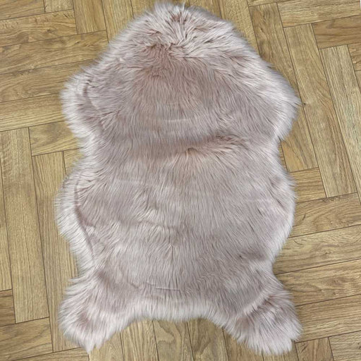 Irresistibly tactile faux sheepskin snug pink rug