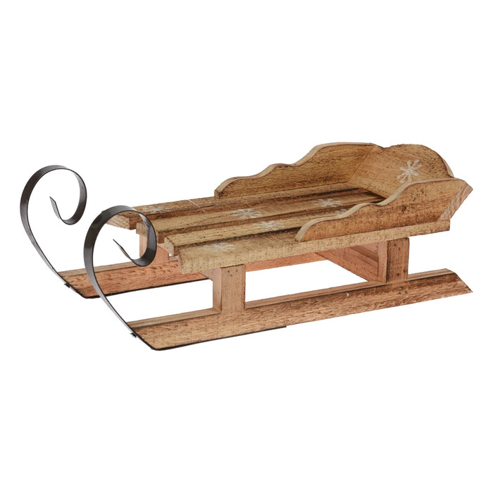 Rustic burned-wood sledge with curled metal runners and painted white snowflakes