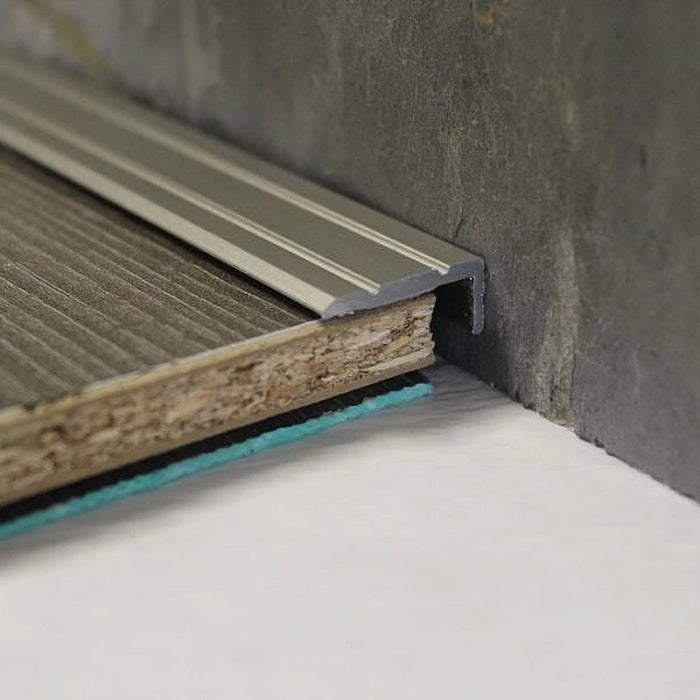 Brushed Silver Angle Edge close-up showing subtle texture next to a dark oak laminate.