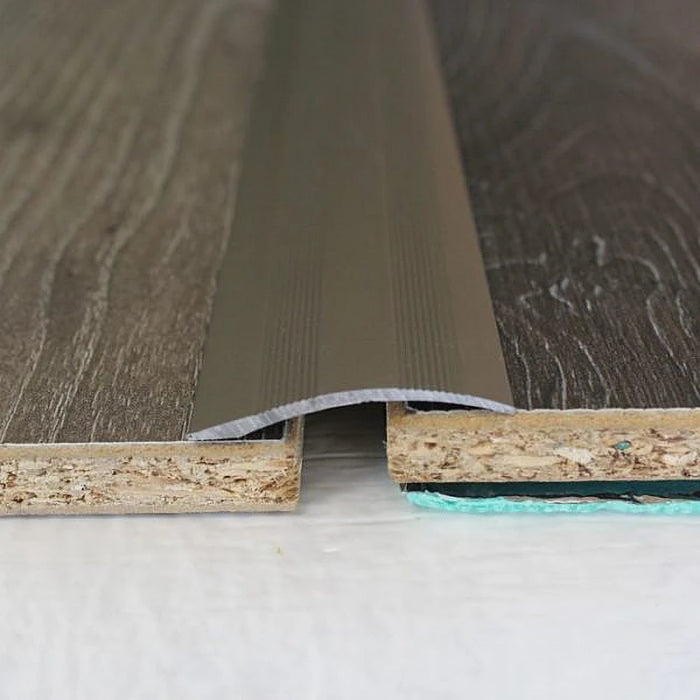 Brushed Silver Uni-coverstrip providing a contemporary join between laminate floorings.