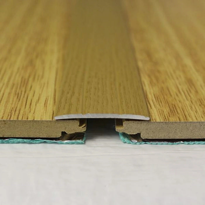 Natural Oak coverstrip blending seamlessly between light rustic-style floors.