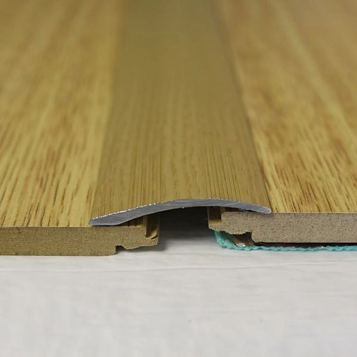 Natural Oak Uni-coverstrip seamlessly bridging rustic wood floorings.