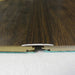 Walnut coverstrip offering a smooth transition between two dark wood floors with a polished finish.