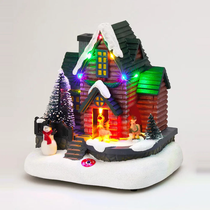 Red log house scene lit up with multicolour LED lights