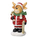Reindeer figurine in a Santa hat and green scarf with a ski and pole on a snowy base