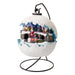Snowball-shaped scene on a black stand with a snowy village, Santa and a train inside
