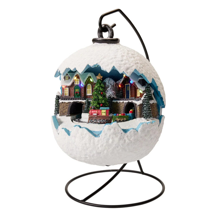 Snowball-shaped village scene with a central Christmas tree and train