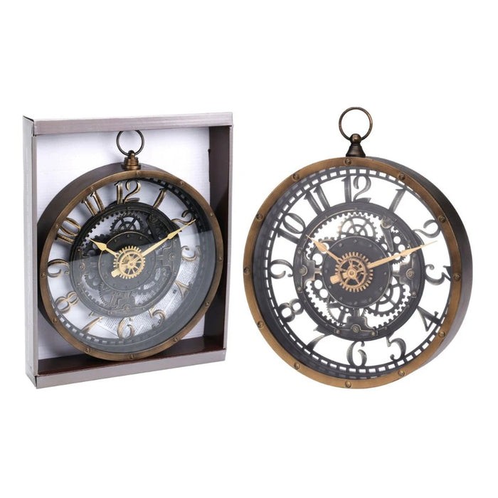 Industrial-style wall clock with a vintage brass-look finish and faux internal gears, hanging on a teal wall beside a mirror, styled in a showroom setting.