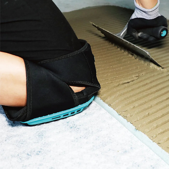 Bihui TKPF Gel Knee Pads placed on a construction site floor with tools and tiles, ready for protective use.