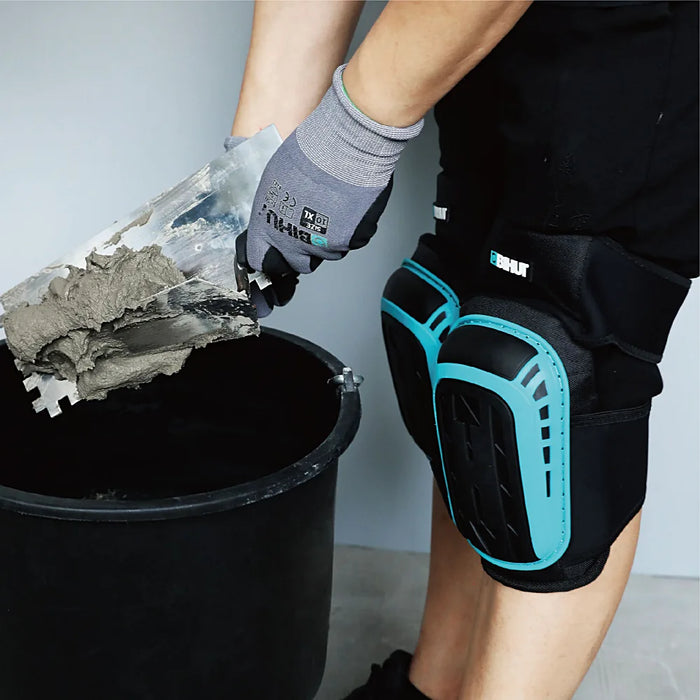 Bihui TKPF Gel Knee Pads placed on a construction site floor with tools and tiles, ready for protective use.