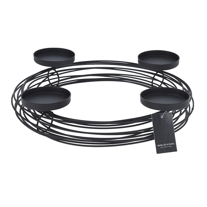 Close-up of black candle holder wreath showing circular metal frame and candle placements.