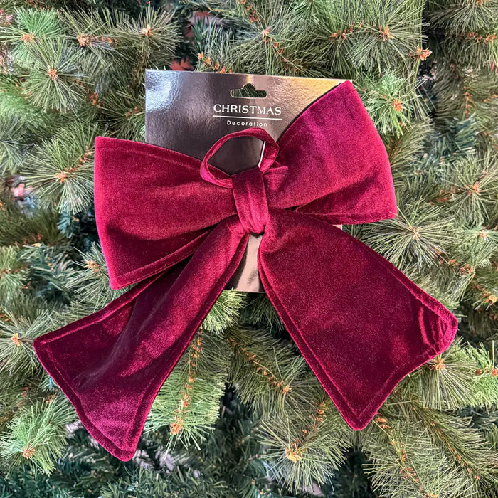 Close-up of soft burgundy velvet bow showing rich texture and smooth fabric finish.