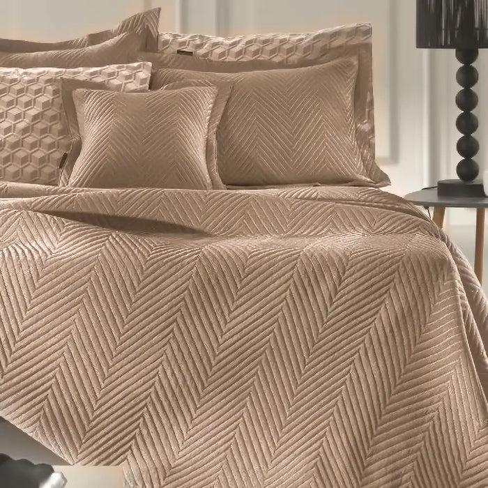 Camel Margot bedspread styled on a bed, showing quilted texture and warm camel tone in a modern bedroom.