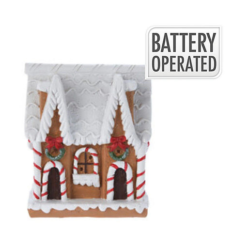 Close-up of Candy Cane Cookie House showing candy-striped details and illuminated windows.