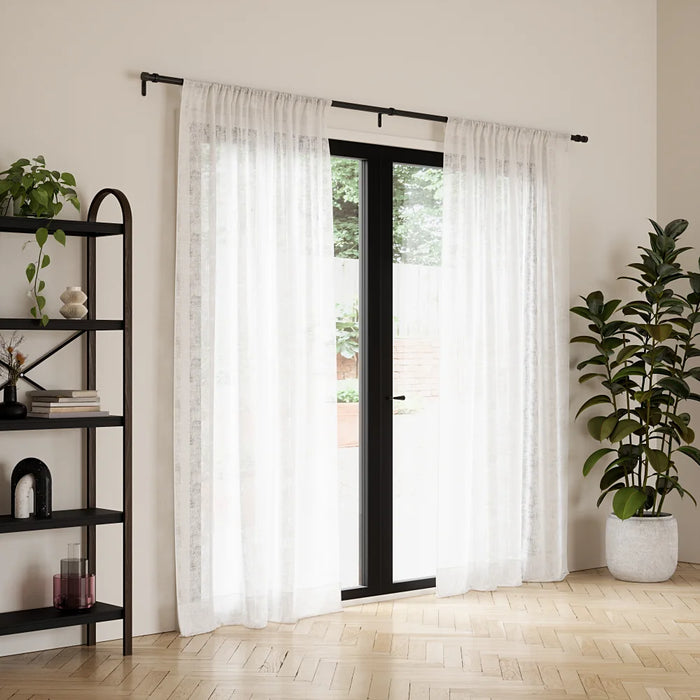 Cappa matt black extendable metal curtain pole with finials and wall brackets laid out for installation
