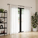 Cappa matt black extendable metal curtain pole with finials and wall brackets laid out for installation