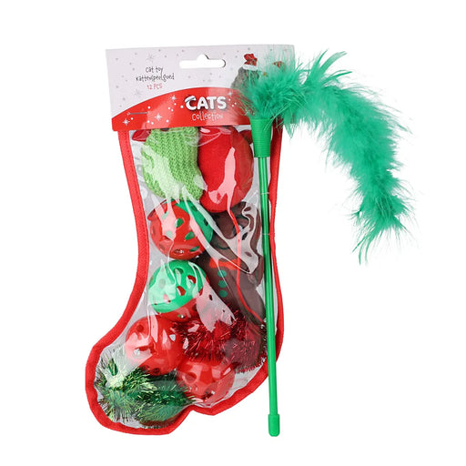 Close-up of green feather cat toy and other small toys inside a red Christmas stocking.