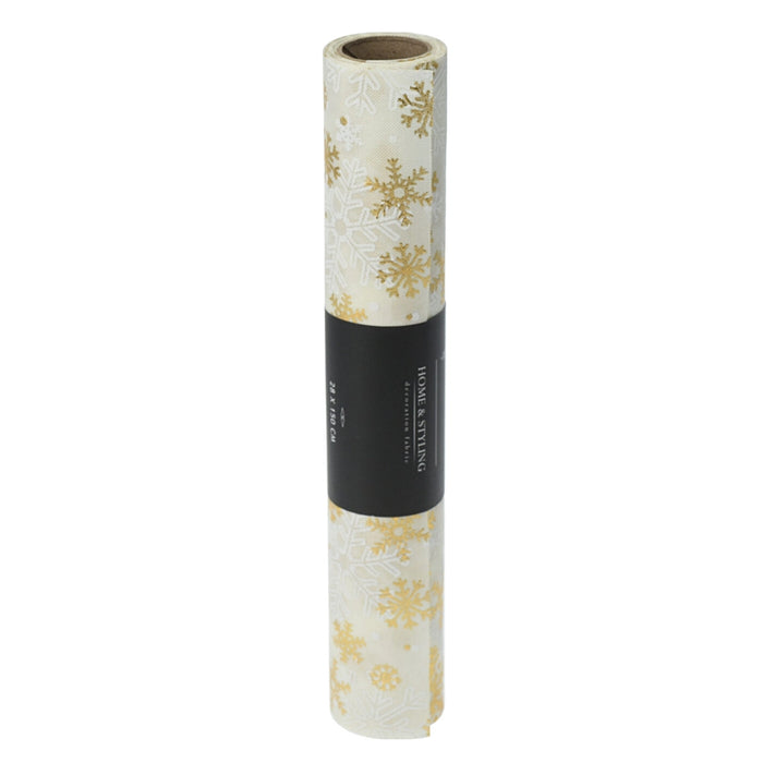 Close-up of cream fabric with gold snowflake embroidery.