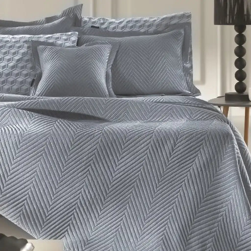 Denim Margot bedspread styled on a bed, showing deep denim blue quilted finish in a stylish room setting.