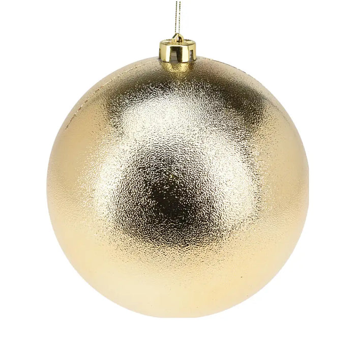 Close-up of dimpled gold bauble showing textured reflective surface.