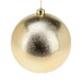 Close-up of dimpled gold bauble showing textured reflective surface.