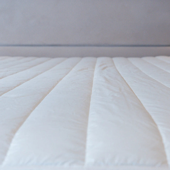 Dooleys Irish Wool All Season Duvet folded on a bed showing natural wool bedding for year round comfort