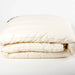 Dooleys Irish Wool All Season Duvet folded on a bed showing natural wool bedding for year round comfort