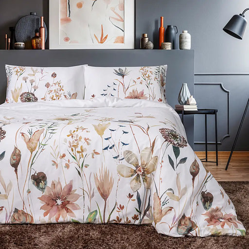 Estoril Print duvet set styled on a bed, showing elegant patterned design in a light-filled bedroom.