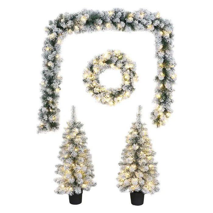 Close-up of snowy garland showing pinecones, faux greenery, and glowing LED lights.