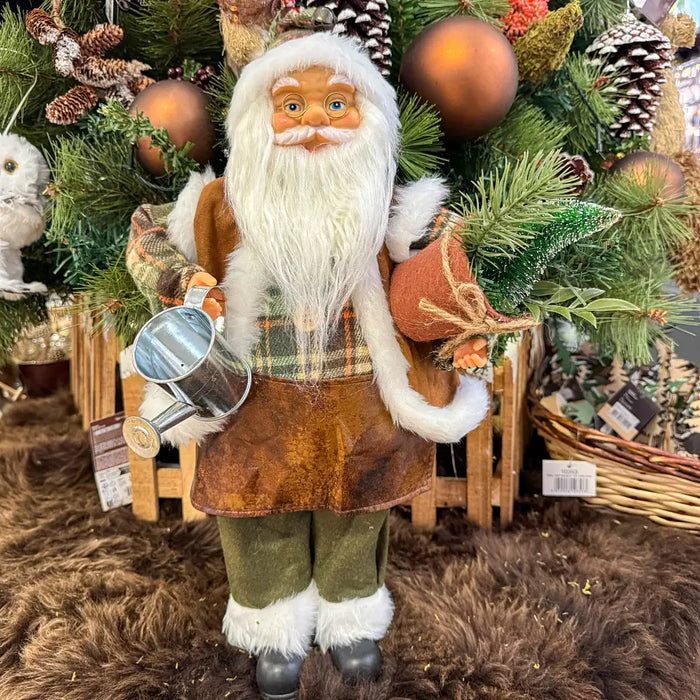 Close-up of Gardener Santa Figure showing detailed outfit, face, and miniature gardening tools.