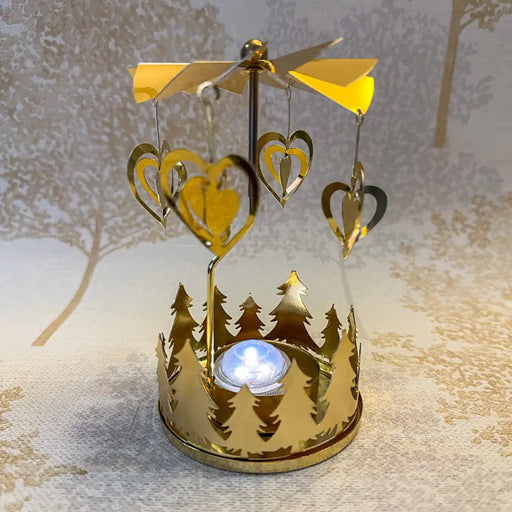 Close-up of gold heart carousel tealight holder showing delicate heart shapes reflecting light.