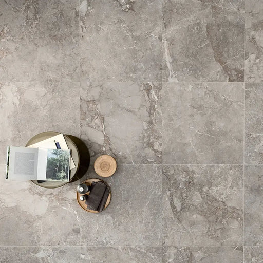 Modern interior styled with Golden Age Grey Porcelain tiles, featuring bold grey tones with warm onyx-inspired veining.