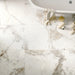 Close-up of Golden Age White Porcelain tile surface, highlighting fine grey and gold veins on a white marble-inspired background.