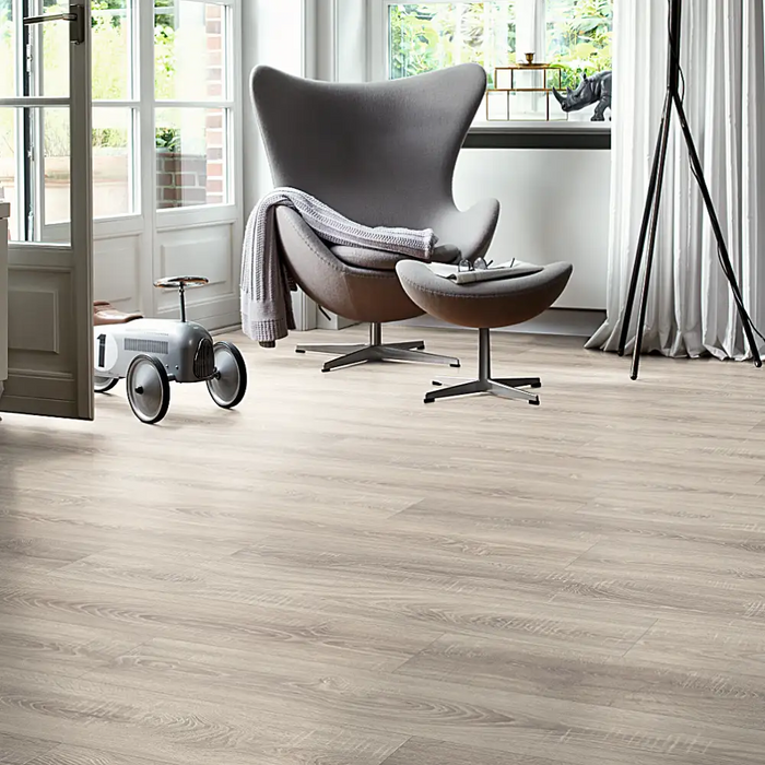 Dawn Oak laminate flooring in a bright interior, showing soft grey tones and natural wood markings for a clean and versatile finish.