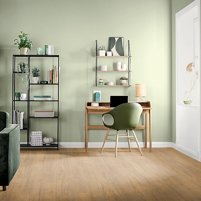 Golden Oak laminate flooring displayed in a cosy, country-style living room, showing warm honey tones and natural oak texture.