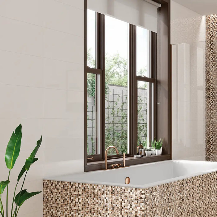 Bright bathroom with Blanco Brillo tiles installed on the walls, creating a clean and polished look.