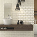 Bathroom splashback tiled with Homeful Essentials Metro Marfil tiles, adding warmth with a glossy ivory tone.