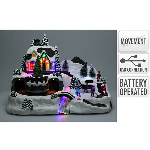 Close-up of Ice Skating and Train Christmas Village showing detailed miniature figures and illuminated LED features.