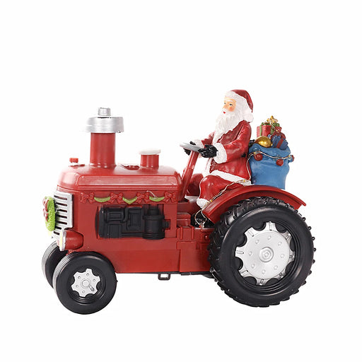 Christmas ornament of Santa driving a red tractor with his sack of presents