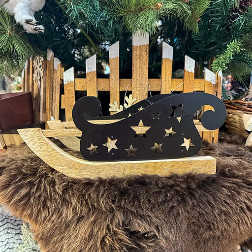 Close-up of mango wood Christmas sledge showing its smooth finish and natural wood texture.