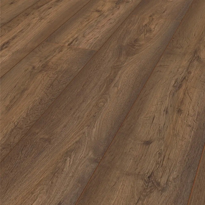 Close-up of Modena Oak 8mm laminate flooring, showing its rich dark tones and authentic woodgrain texture.