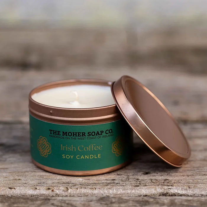 The Moher Soap Co. Irish Coffee scented soy candle handmade in Ireland in a tin beside a coffee mug