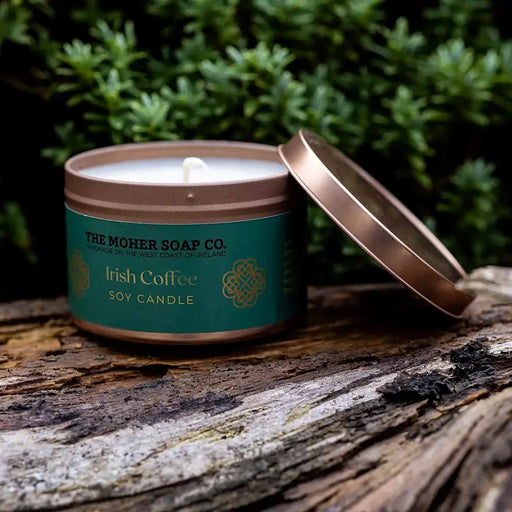 The Moher Soap Co. Irish Coffee scented soy candle handmade in Ireland in a tin beside a coffee mug