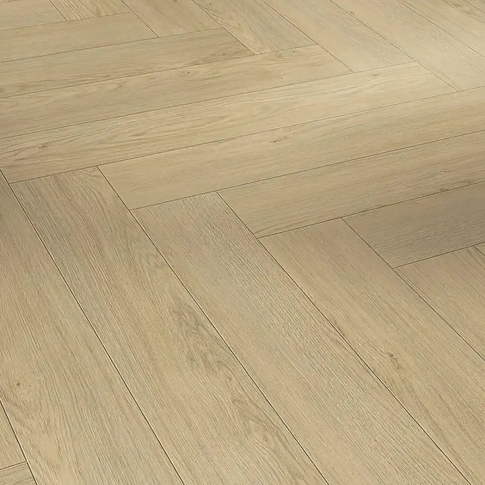 Close-up view of Mont Blanc Sanded Herringbone plank showing its natural oak grain, matt sanded texture, and refined parquet-style edge detail.