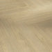 Close-up view of Mont Blanc Sanded Herringbone plank showing its natural oak grain, matt sanded texture, and refined parquet-style edge detail.