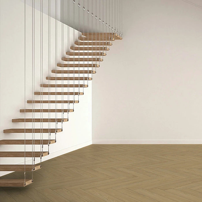 Mont Blanc Sanded Herringbone laminate flooring in a cosy, classic living room setting, featuring warm oak tones and elegant herringbone design.