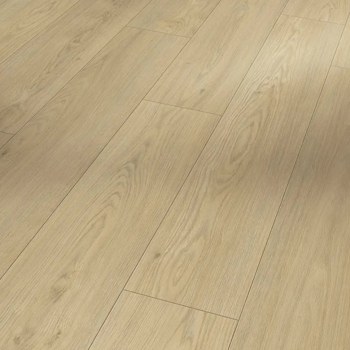 Close-up of Mont Blanc Sanded laminate flooring showing its subtle wood grain detail and soft matte texture in a light oak finish.