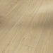 Close-up of Mont Blanc Sanded laminate flooring showing its subtle wood grain detail and soft matte texture in a light oak finish.