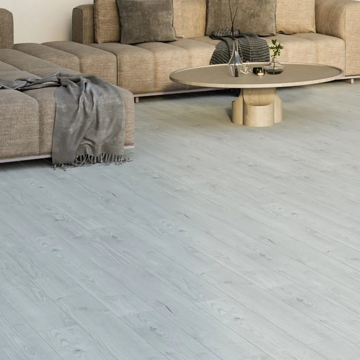 Orion Pulsar laminate flooring styled in a clean interior setting, showcasing its narrow plank design and subtle oak grain for a refined and modern look.