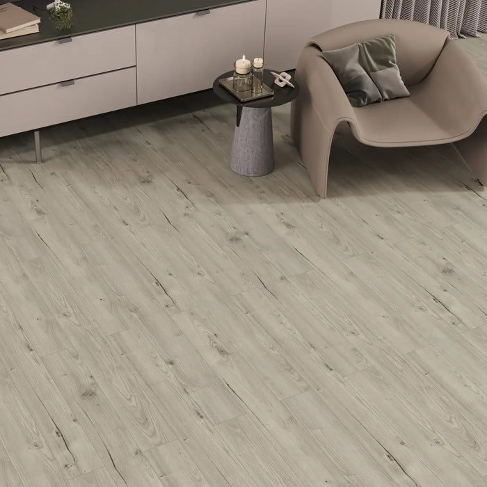 Orion Shimmer laminate flooring shown in a bright, modern living area with minimalist décor, where the soft oak tone and narrow plank layout create a sleek, polished look.